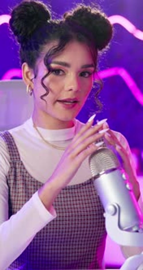 Woman, podcast and hands on microphone on neon background for audio or sound therapy and ASMR