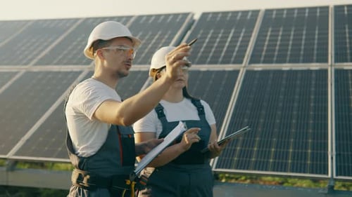 An Engineer and His Assistant Check the Operation of Solar Panels