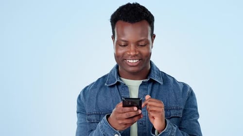 Happy black man, phone and laughing for funny joke, social media or meme on a studio blue