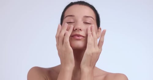 Woman Massaging Face for Skincare and Beauty