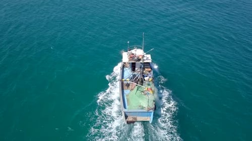 Small fishing boat at sea - Aerial footage.