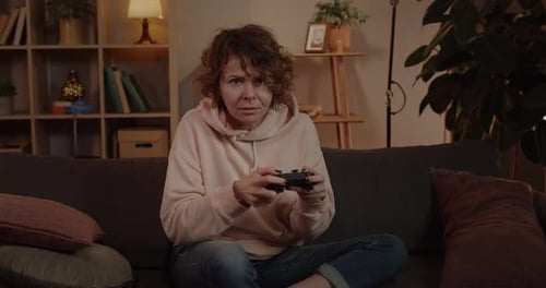 Woman Focused on Playing Video Game at Home