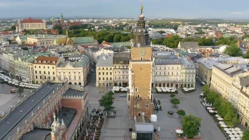 Incredible Aerial Establishing Shot of Town Hall Tower in Krakow's Old Town Plaza. Cinematic View