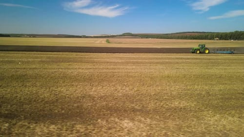 Tractors plowing the field in Ukraine