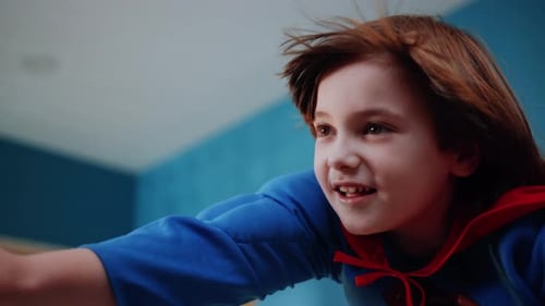 A Young Superhero Enthusiastically in Action Wearing a Colorful Cape Full of Excitement