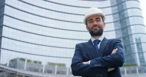 Engineer with the construction helmet, smiling proudly of its construction recently concluded, in