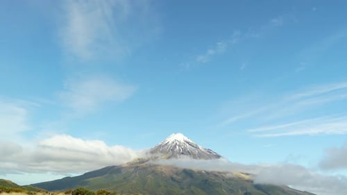 Drone tilt down view revealing lake and Mount Taranaki landscape in New Zealand landscape