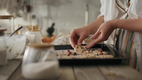 Woman Placing Cookies on Sheet Pan for Baking