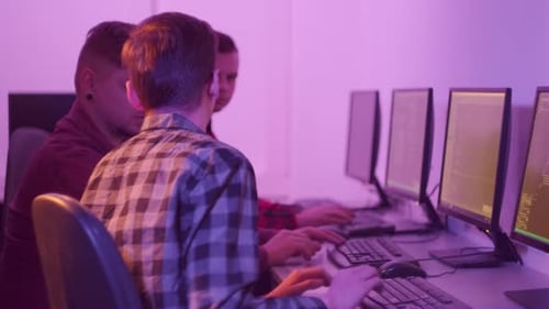 Men in Shirts Programmers Discuss Work Sitting in the Office at Computers