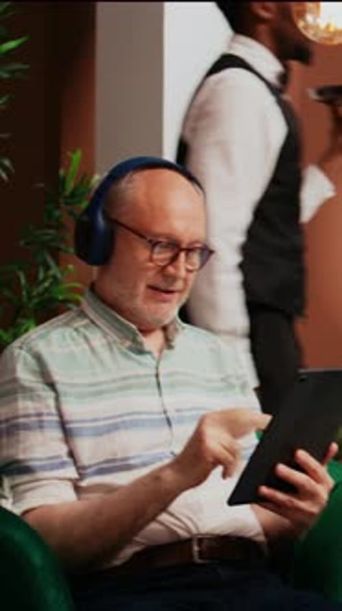 Vertical Video Tourist Having Fun with Gadget at Hotel