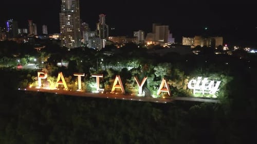 aerial Pattaya city sign illuminated at night