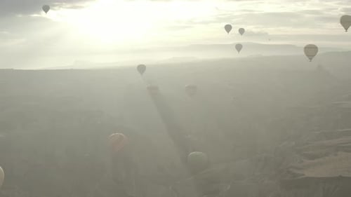 Aerial video of hot air balloons at sunrise, iconic destination behind Cappadocia Turkey
