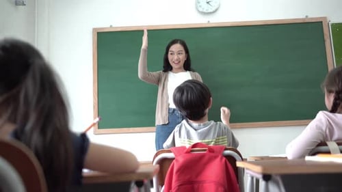 Enthusiastic Students Raising Hands in Classroom