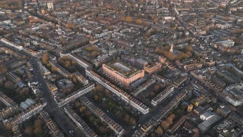 Drone fly-in of luxurious residential buildings showcasing rooftop gardens and pools in London at su