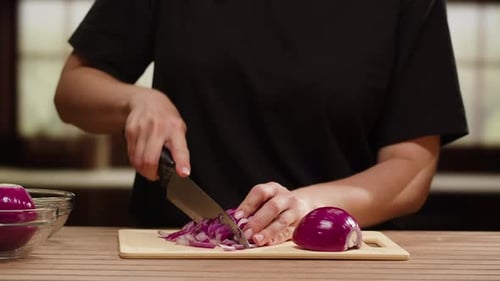 Woman Dices Red Onion in Bright Kitchen