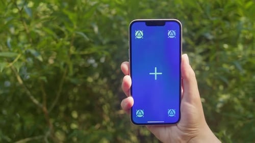 Young Woman Holding Phone Chroma Key Screen in Front of Green Trees in the Park Closeup Girl with