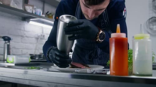 Chef Plating Gourmet Dish in Commercial Kitchen