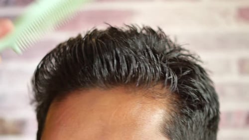 Man Styling Hair with Comb Close Up