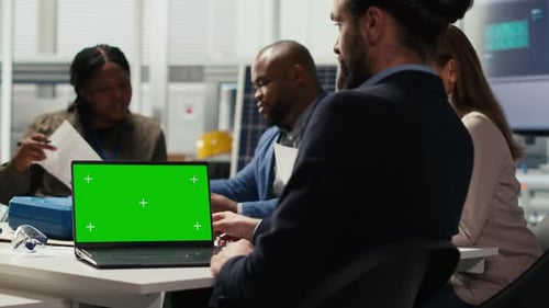 Photovoltaics Factory Team Using Green Screen Laptop