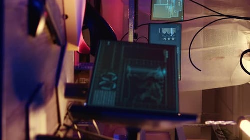 Futuristic monitors with code illuminated by neon lights