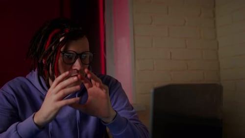 Man Speaking and Gesturing While Video Conferencing