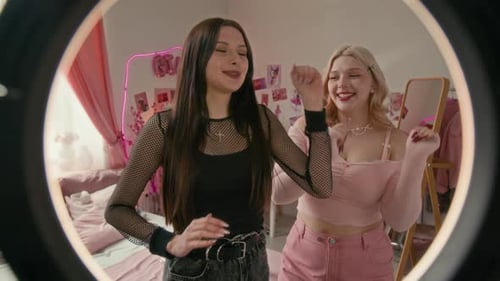 Two Young Women Dancing in Bedroom with Ring Light