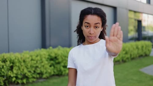 Young Woman Holds Hand Up To Say No