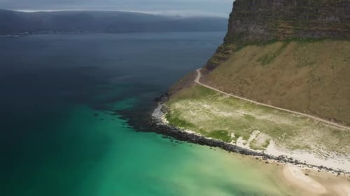 Breathtaking Aerial View of Coastline and Cliffside Road