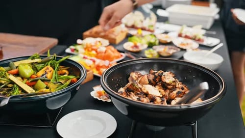 Captivating Slow Motion Footage Showing a Mouthwatering Buffet Spread with a Variety of Delectable