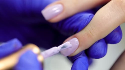 Applying Lilac Nail Polish to Manicured Nail