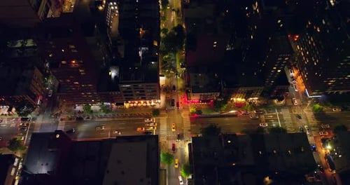Crossroads with a number of cars at night time. Birds' eye view on the city traffic of New York.