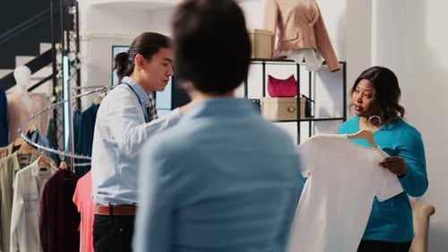 Sales Associate Helping Customers Shop in Boutique
