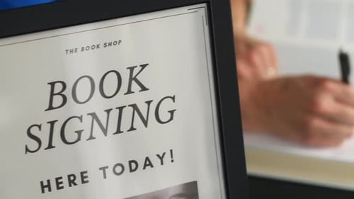 Author Signing a Book at Book Signing Event