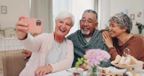 Smiling Senior Friends Take a Selfie at Tea