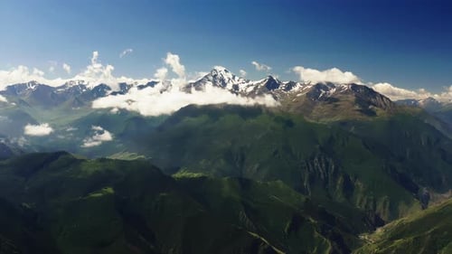 Dramatic Aerial View of Snowcapped Mountains Rising From Clouds SnowCapped Mountains Emerging From