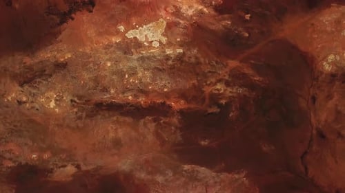 Aerial view of the colorful textured ground at the geothermal area of Hverir, Iceland, with mud hole