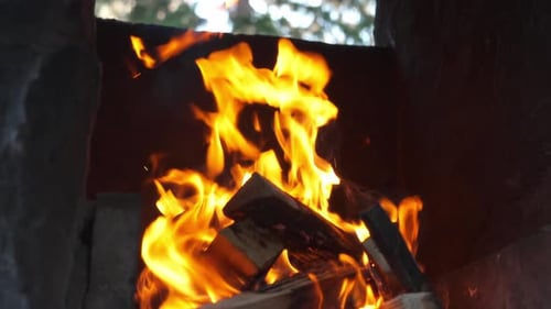 Intense flames burning wood in a close-up shot with glowing orange fire in the hearth