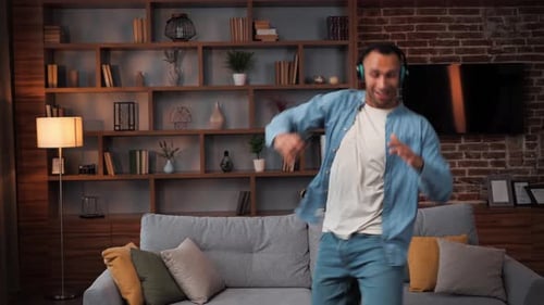 Man Listening to Music and Dancing at Home