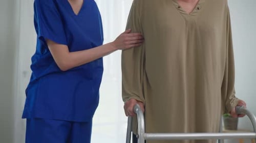 Supportive Nurse Helping Senior Woman with Walker