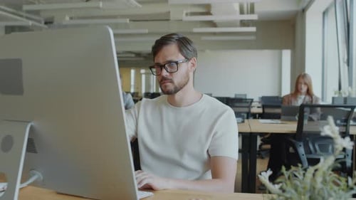 Businessman Using Computer in Modern Coworking Office