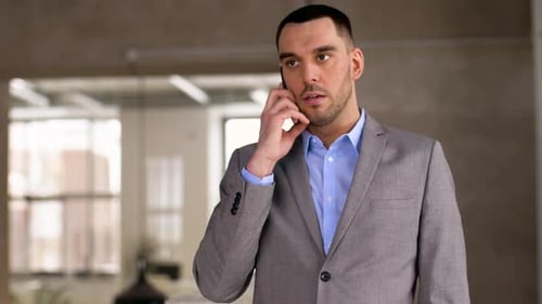 Man in Suit Talking on Phone at Work