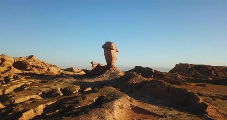Fly around a wind erosion pillar stone rock cliff landform formation in ...