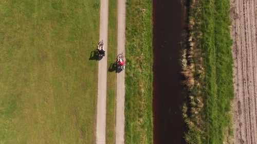 Aerial view of cyclists on road by canal, Bourtange, Groningen, Netherlands.
