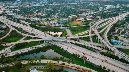 Road interchange of highways and freeways in colorful Miami. City scenery with lively traffic
