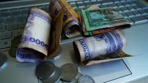 Bangladeshi Taka Currency on a Laptop Keyboard