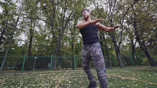 Young man exercise outdoors. Athletic man training at the stadium