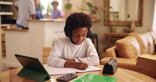 Young Person Studying at Table with Headphones