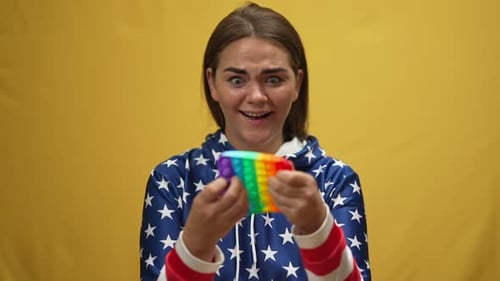 Young Woman Plays with Pop-It Fidget Toy