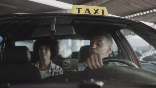 Taxi Driver Smiles at Paying Passenger
