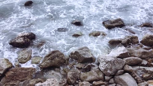 Waves Crashing on Rocky Seashore in Daytime
